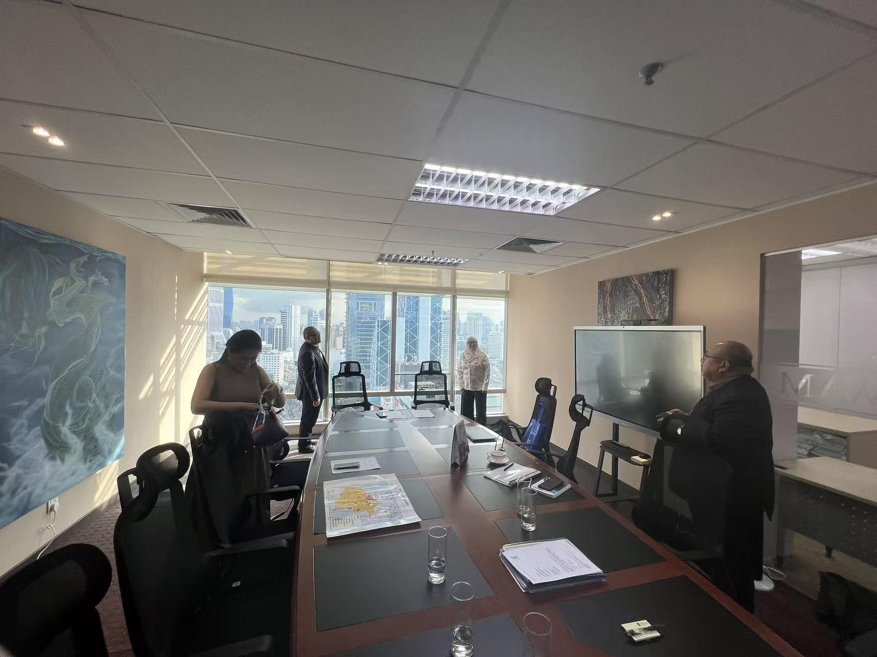 Commercial discussion on a Malaysia upstream gas project — concession map review and project scoping session.